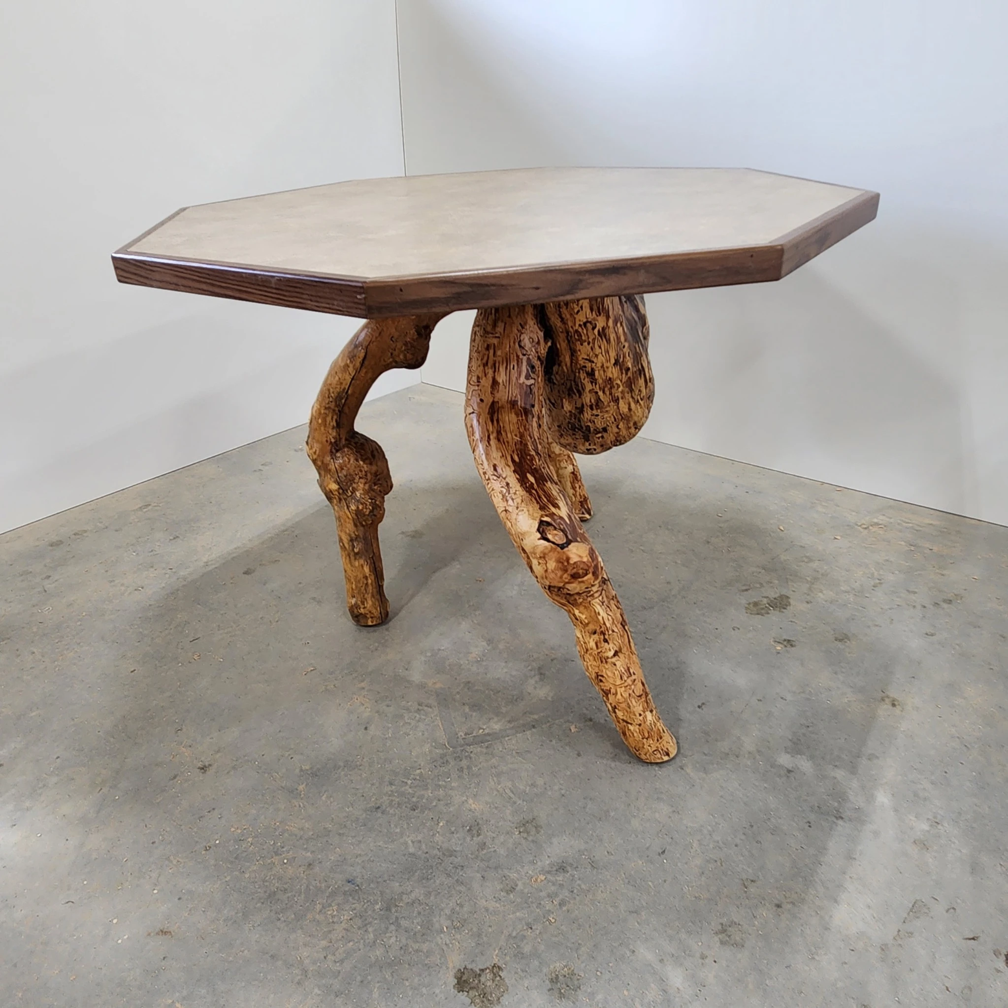 Small octagonal wood table with sculptural natural branch legs